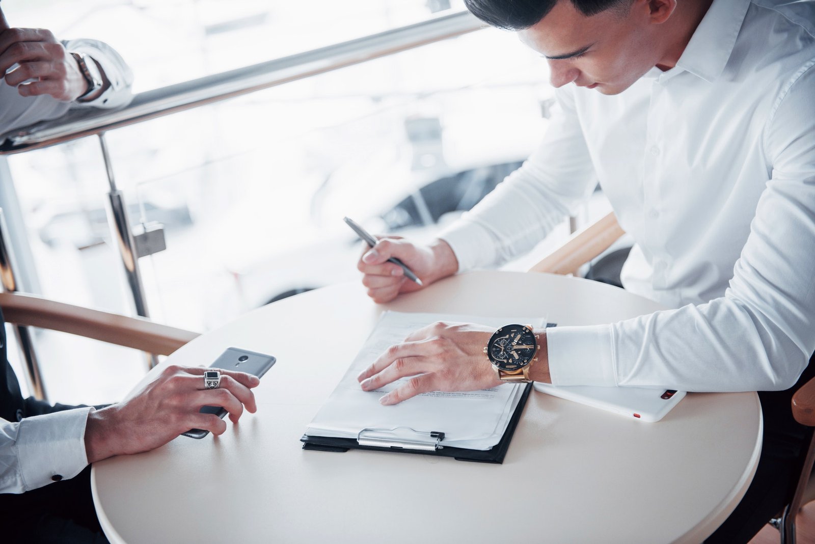 Young man signs documents in the office, successful sales