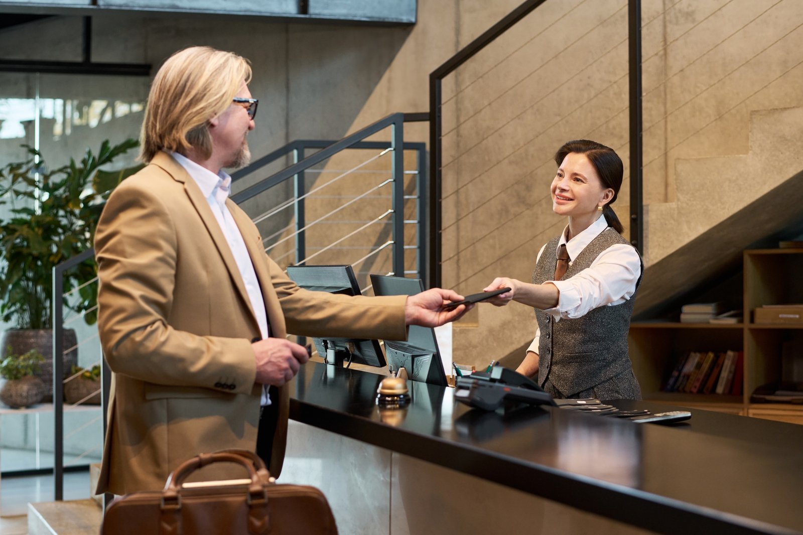 Handing ID Card to Receptionist at Office Counter