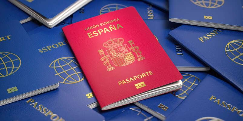 Passport of Spain on the pile of passports of other countries.