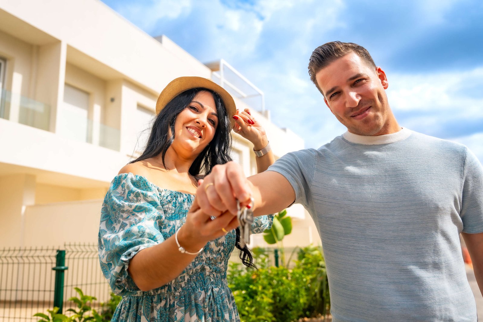 Happy couple holding the keys to a new home in Valencia