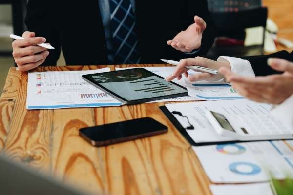 Close up diverse colleagues working on project together, working with legal documents, financial